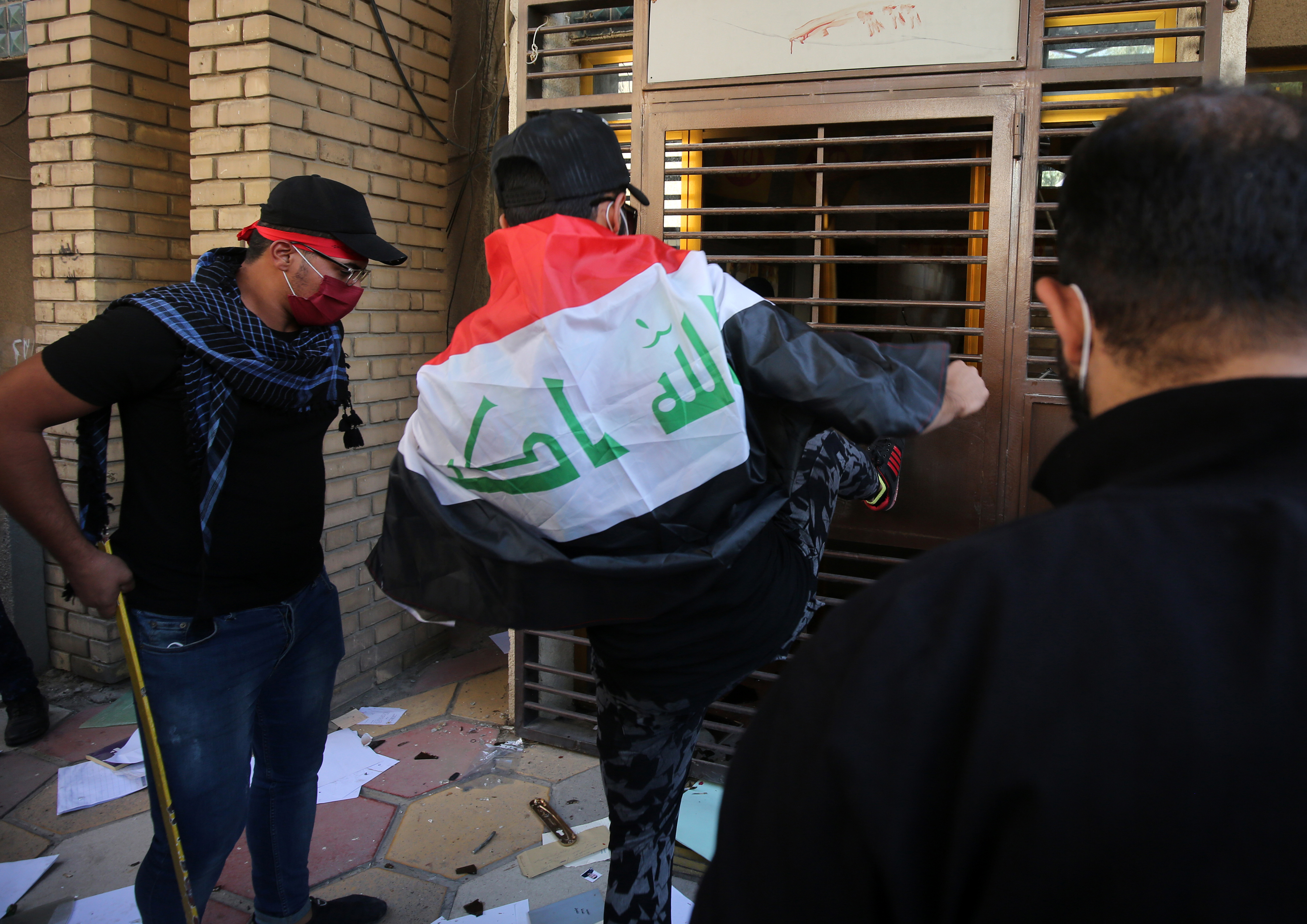 Iraqi demonstrators, supporters of the pro-Iranian Hashed al Shaabi, attack the Kurdish Democratic Party's headquarters in the capital Baghdad on Oct. 17, 2020. (Ahmad al-Rubaye / AFP)