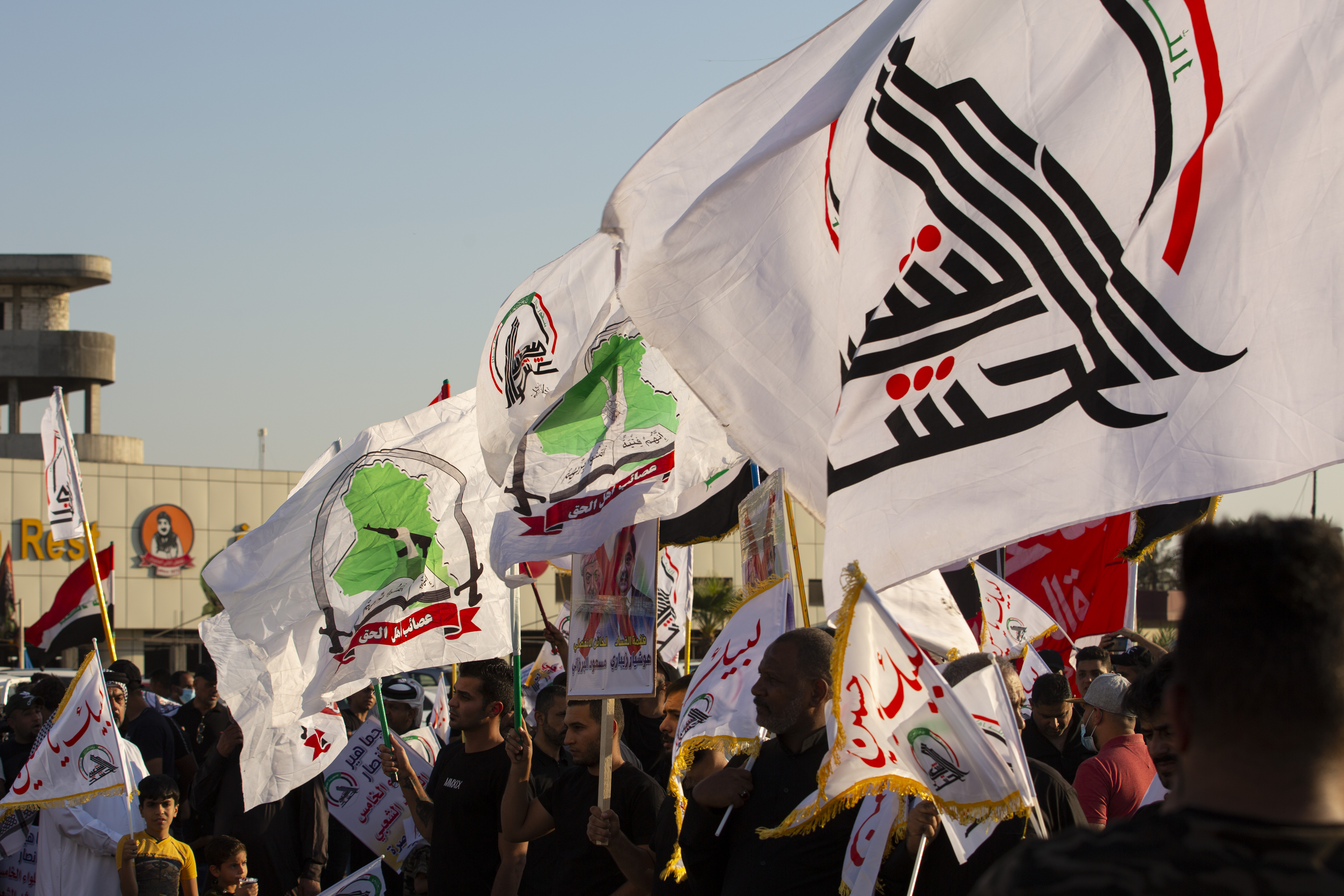Iraqi paramilitary network dominated by Iran-backed factions, wave the Hashed flag during the attack,, Oct. 17, 2020. (Photo: AFP/Ahmad al-Rubaye)
